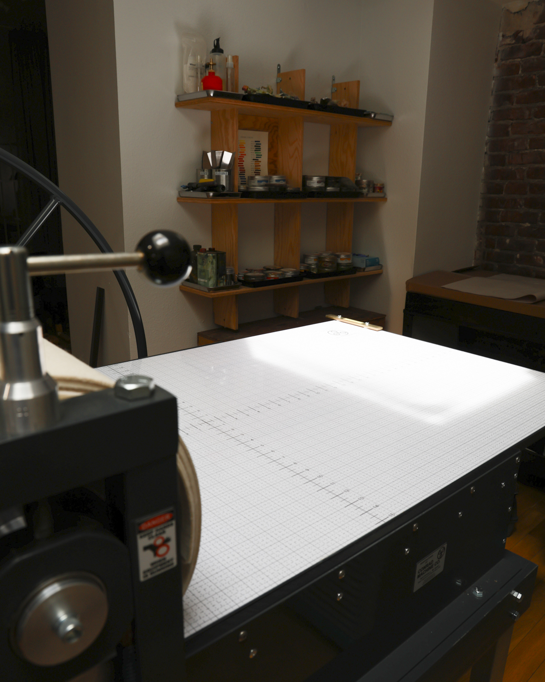 Conrad E31 press bed (60 × 30.5 inches), prepared for large-scale print work.